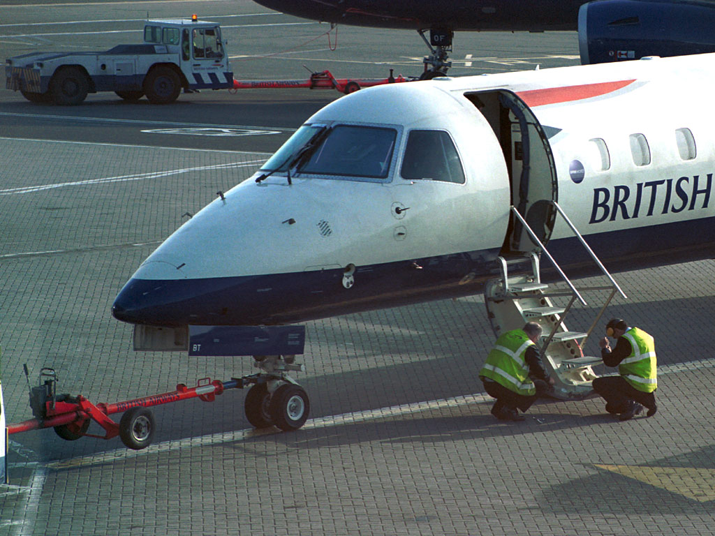 G-EMBT BA Citiexpress being attended to by eningeers at GLA Stand 18 (15 May 2003 - 0735)
